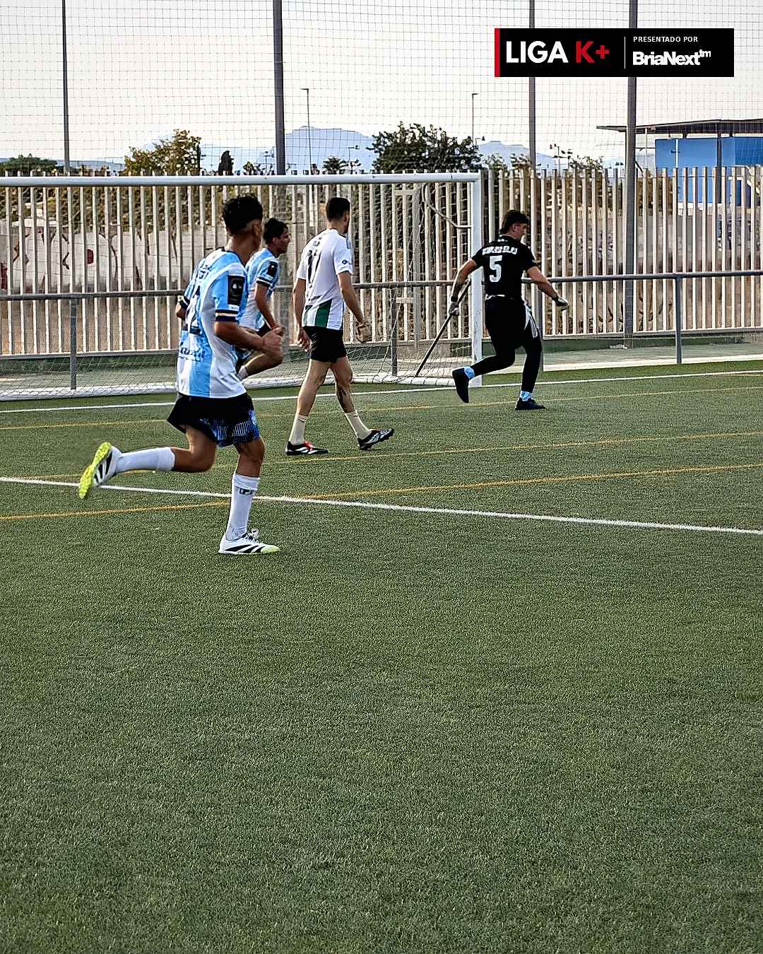 Futbolistas disputando el balón en partido amateur, foto real Liga K+